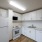 Open Kitchen Layout with White Modern Appliances and Cabinetry